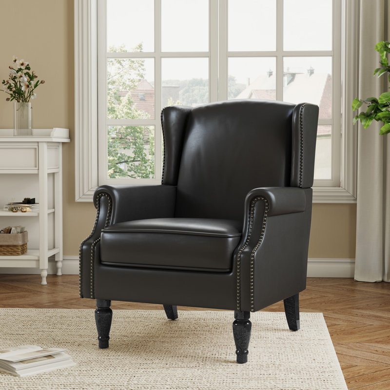 Fauteuil à oreilles en similicuir noir rembourré avec garniture cloutée Duward, Similicuir noir