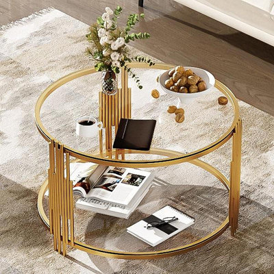 Modern Glass Coffee Table With Asymmetrical Metal Base, Circular Drum Design, Gold Finish, And Lower Shelf For Extra Storage