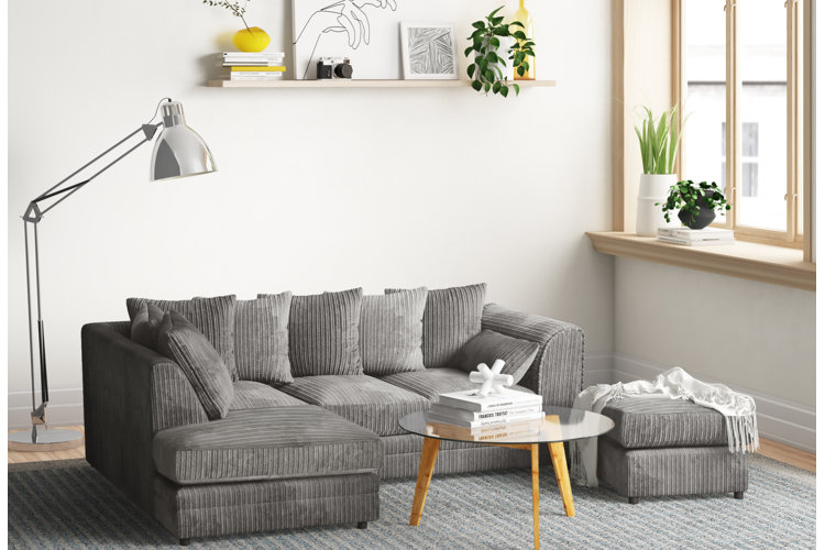 gray living room couch ottoman rug lamp