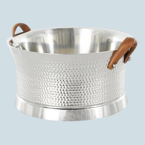 Silver hammered metal ice bucket with brown leather handles.