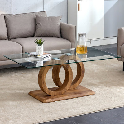 Une table basse rectangulaire moderne et tendance avec un plateau en verre trempé et des pieds en grain de bois. Convient au salon: 47,2 po x 25,4 po x 17,9 po