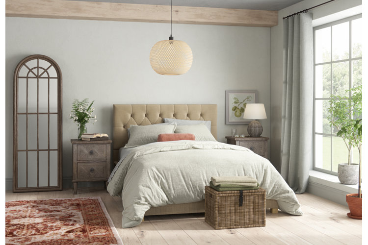 neutral bedroom with a beige upholstered headboard