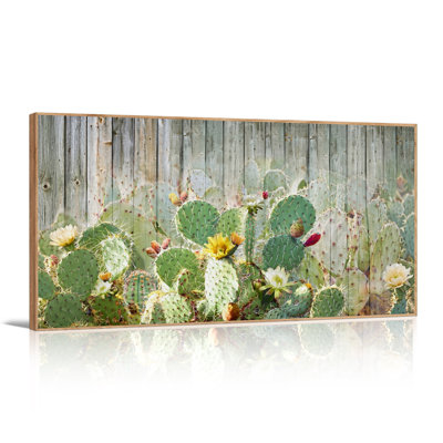 Tableau sur toile représentant un cactus figuier de Barbarie à fleurs jaunes sur une clôture en bois
