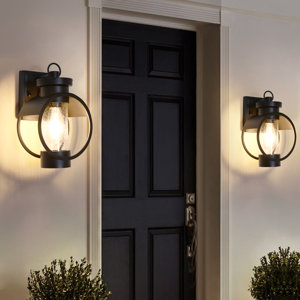 https://assets.wfcdn.com/im/92025749/resize-h300-w300%5Ecompr-r85/1304/130482101/Joelle+Black+1+-+Bulb+11.8%27%27+H+Glass+Outdoor+Wall+Lantern+with+Dusk+to+Dawn.jpg