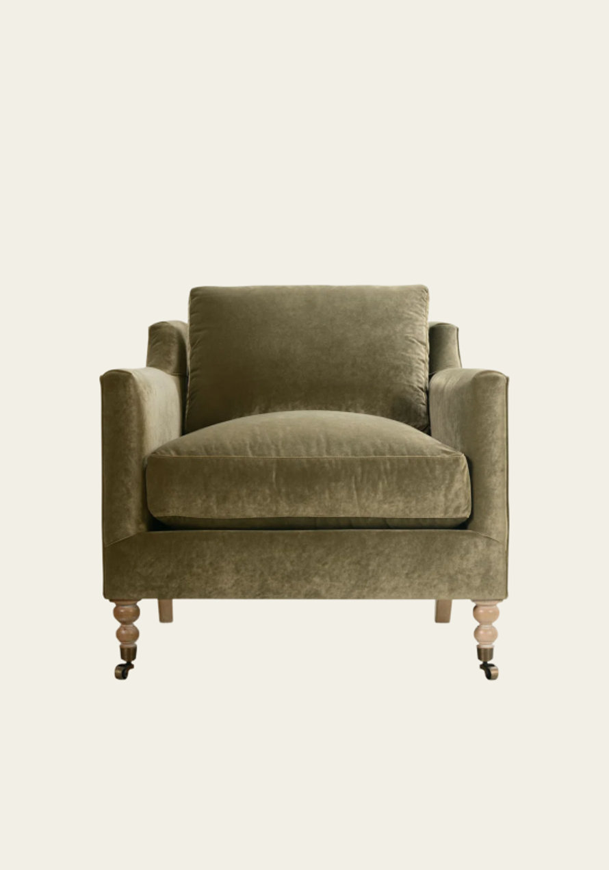 Upholstered olive green armchair.