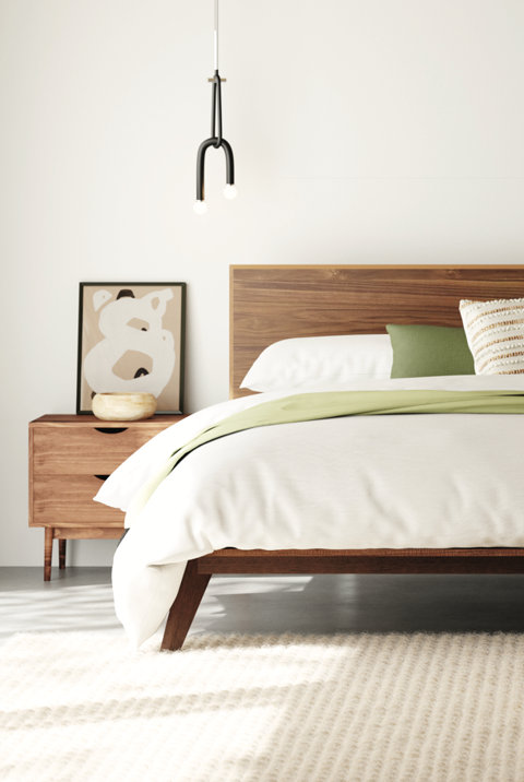 Bedroom with pendant light, wood headboard, and neutral decor.