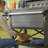 Keter Outdoor Patio Cooler Chest, 89.8 Qt Beverage Bar Cart w/ Wheels, Graphite