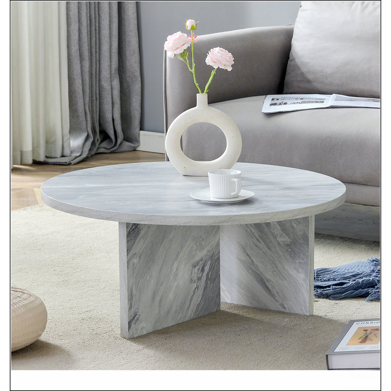 Une table basse ronde en panneau de fibres à densité moyenne blanche de style multi-style, avec un minimalisme moderne et une touche nordique, avec des dimensions de 31,5 x 31,5 x 13,98 pouces.