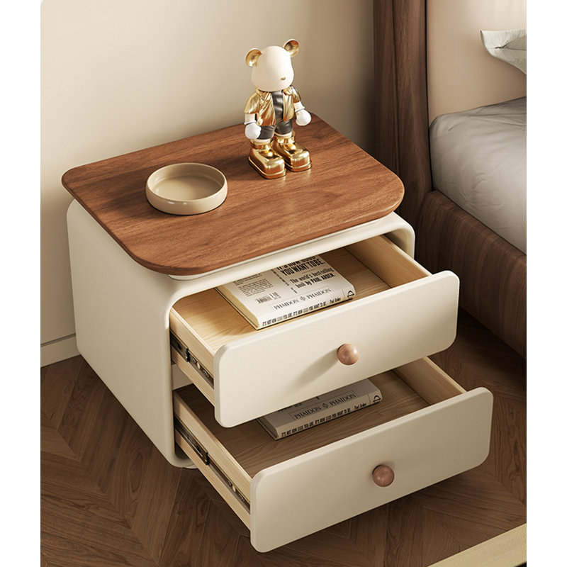 Table de chevet minimaliste de couleur crème, avec des tiroirs en bois massif et des rails coulissants silencieux, convient à une utilisation dans la chambre à coucher.