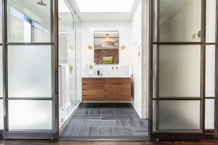 modern bathroom with natural stone floor files and marble walls
