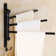 Wall-mounted oscillating towel rack for bathroom use with practical hooks
