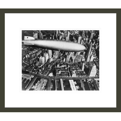 The German airship the Hindenburg above Manhattan New York in 1936 on its way to its berth at Lakehurst  New Jersey the same place where it inexplicably burst into flames the next year. by  -Framed Giclee Print