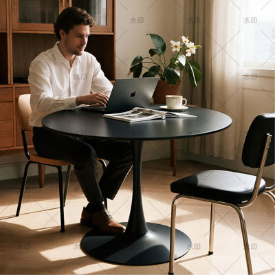 A light luxury style white round dining table with an elegant tulip-shaped steel base and a 24-inch medium-density fiberboard tabletop in a modern med