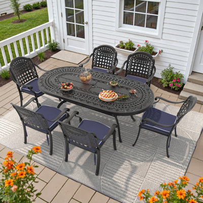 7-Piece 81.89 " L 41.34 " W Oval Table Cast Aluminum Outdoor Dining Set with Umbrella Hole and Blue Cushions by Bloomsbury Market