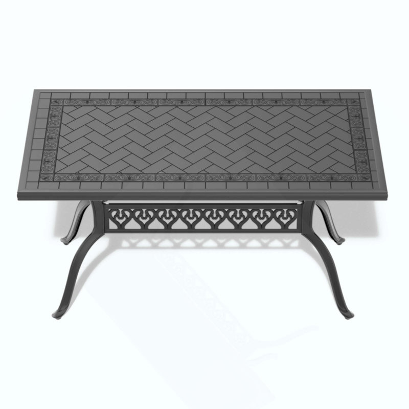 Table de salle à manger en fonte d'aluminium avec cadre et texture sculptée sur le plateau de table