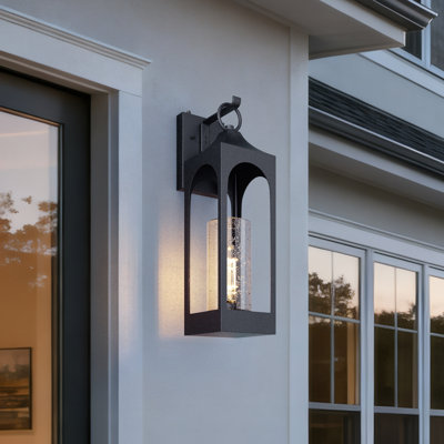 Marla Dusk to Dawn Iron Wall Light with Seed Glass Shade