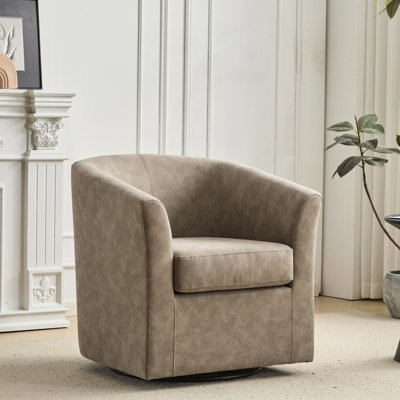 Fauteuil club pivotant en similicuir abricot, pivotant à 360°, design baignoire, finition dorée, largeur 72 cm, hauteur 79 cm, profondeur 77 cm.