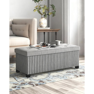 Banc ottoman de rangement pliable en velours gris avec pieds, repose-pieds rembourré et coffre de rangement dissimulé pour chambre, salon et entrée.