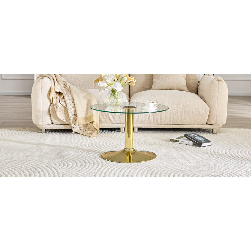 Table basse ronde en verre trempé de 27,5 pouces de diamètre. 17,7 pouces de haut, soutenu par une base en métal doré, avec un bord de luxe léger.