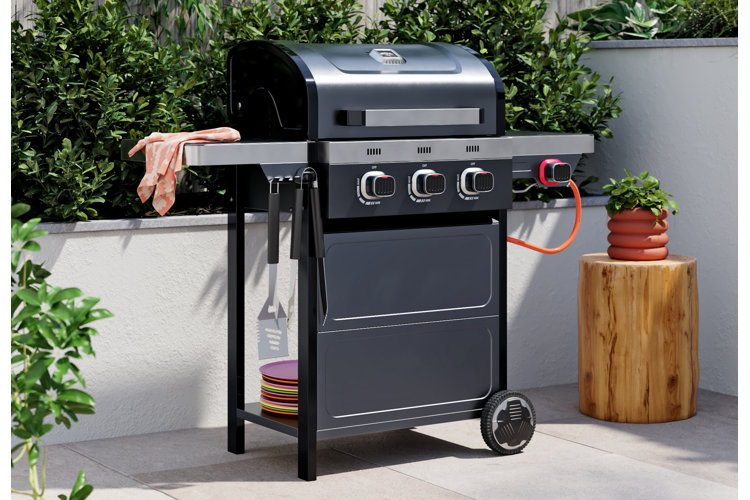 large black grill with food cooking and all cooking utensils on the side
