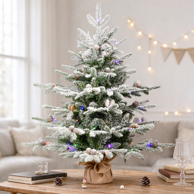 Sapin de Noël artificiel de table floqué et préilluminé avec lumières DEL bicolores et base en toile de jute
