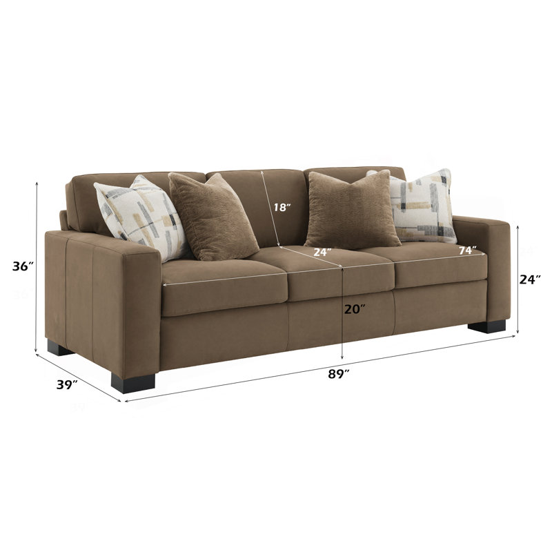 Canapé confortable en suède avec plusieurs coussins et fabrication robuste