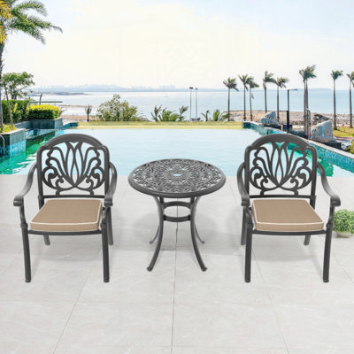 Set Of Cast Aluminum Patio Furniture With Black Frame And Seat Cushions In Random Colors