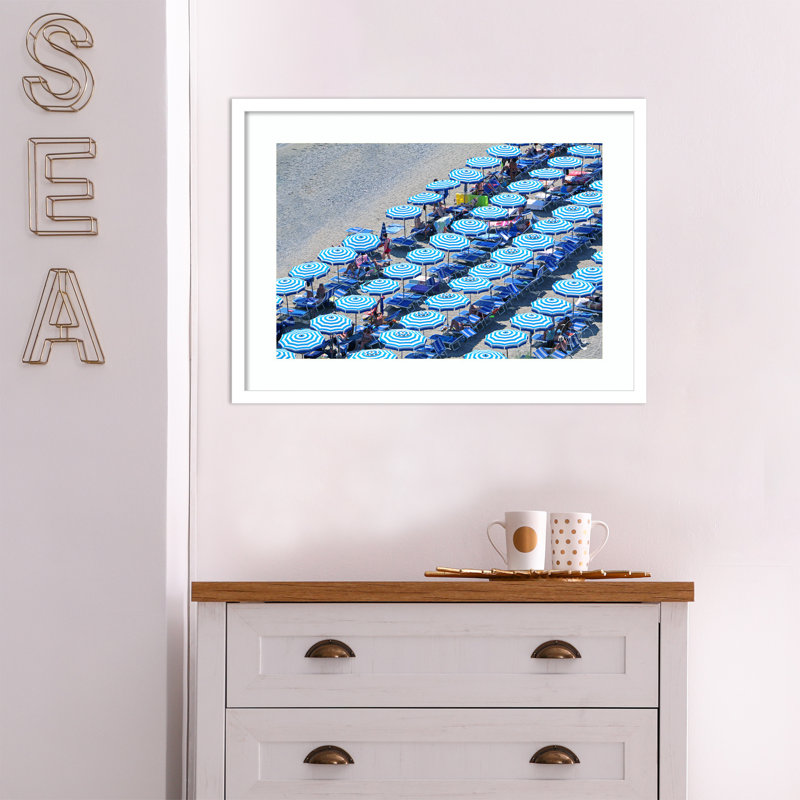 " Umbrellas Of Monterosso " by Rachel Dowd, 18.56" H x 25.25" W x 0.88" D, White Framed Paper