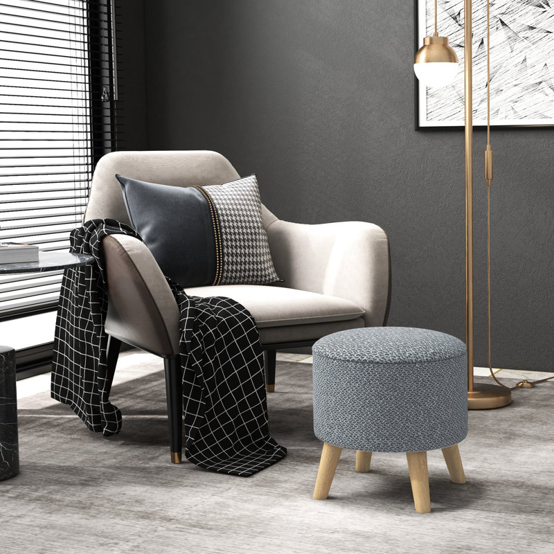 Rangement rond gris avec coussin confortable et repose-pieds dissimulé