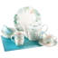 Théière en porcelaine et feuilles vertes