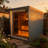 6-Person Traditional Steam Sauna For Outdoor Use, Carbonized Spruce Wood Cabin With Tinted Glass Door, Square Roof And All-Side Aluminum Tile Cladding