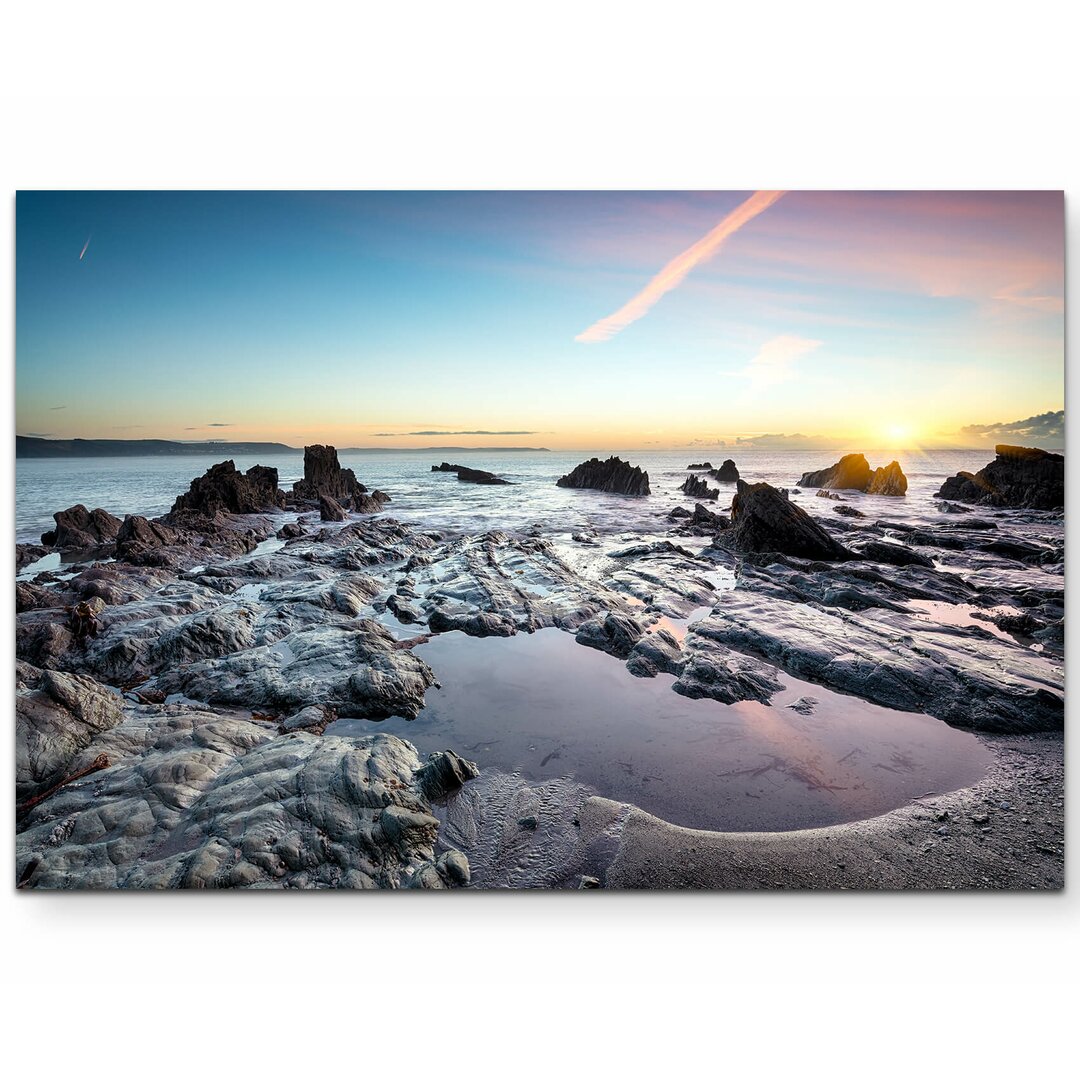 Leinwandbild Steinstrand in England Sonnenuntergang