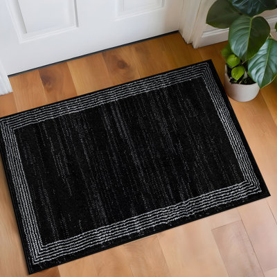 Tapis tissé à motif géométrique noir / ivoire