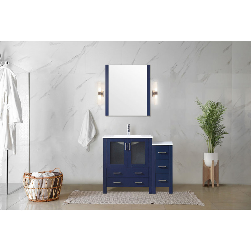 Meuble-lavabo bleu marine de 107 cm de large avec armoire latérale, surface en céramique blanche, miroir de 71 cm, tiroirs à fermeture amortie et grand espace de rangement intégré. Fixation murale.