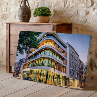 Canvas A Modern Multi Story Building With A Sleek Curved Facade Wall Art Featuring Large Glass Windows And Wooden Accents Showcasing A Canvas Wall Art