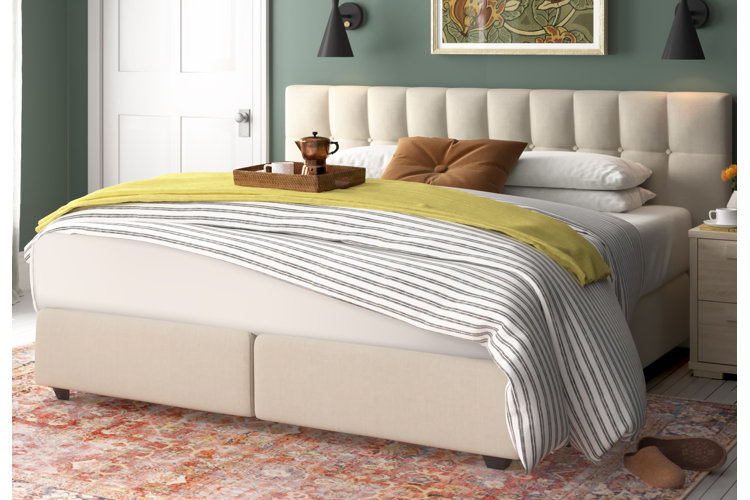 upholstered king bed with white striped bedding in a traditional primary bedroom