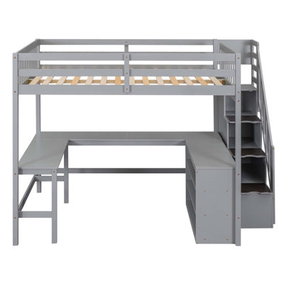 Lit mezzanine avec bureau intégré en forme de L et tablettes de rangement à trois niveaux, et escalier de rangement attaché