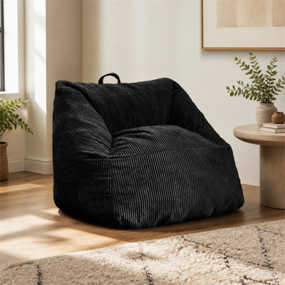 Fauteuil à billes en velours côtelé, assise en mousse, base antidérapante et poche latérale