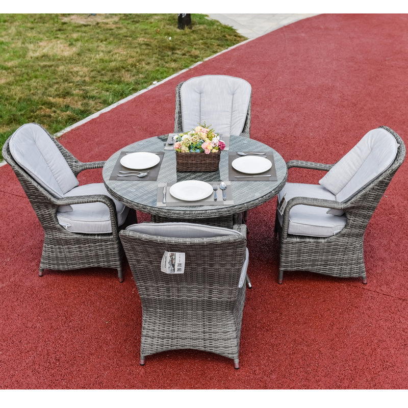 Algird 4 - Person Wicker Patio Dining Set with Round Table , Cushions Included, Gray