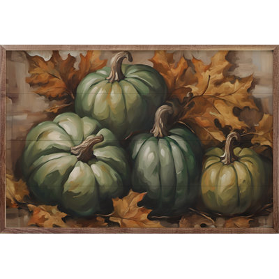 Quatre citrouilles vertes en feuilles