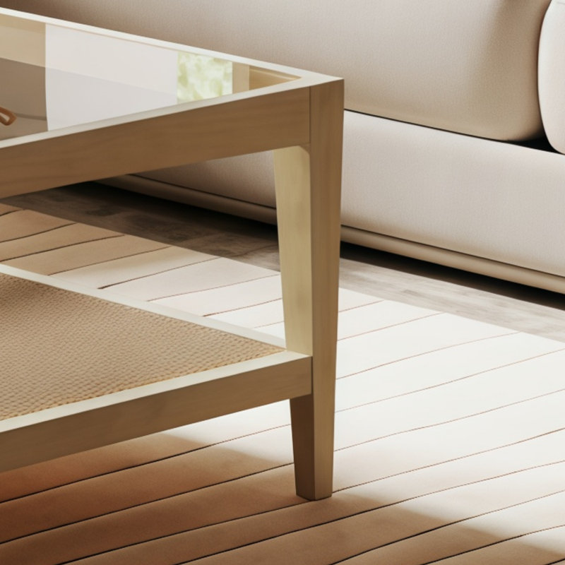 Table basse en bois massif brun clair avec plateau en verre et base en rotin.