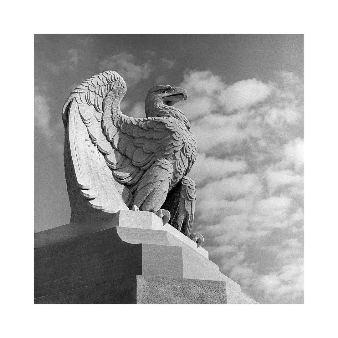 1960s Eagle Statue Against Sky Clouds Wings Spread Feathers by Vintage Images - Wrapped Canvas Print