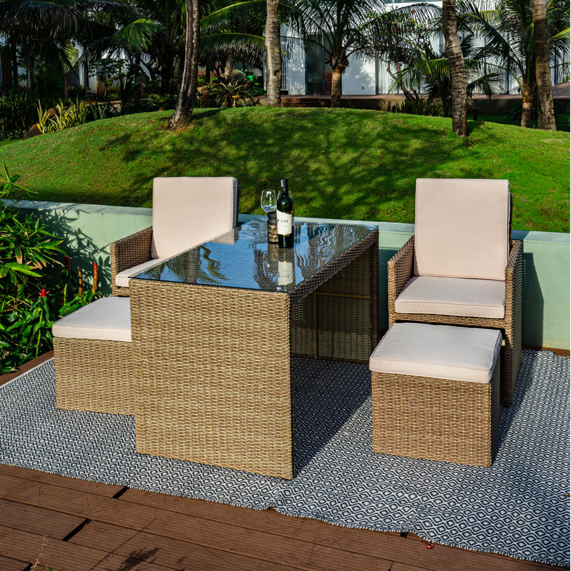 Karelia 4 - Person Patio Dining Set Rectangular Table with Cushions Included