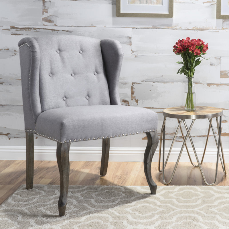 Fauteuil à oreilles haut dossier Kd avec dossier classique et clous élégants, idéal pour les différentes pièces de votre maison