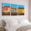 Ensemble de 3 tableaux sur toile représentant un paysage de bord de mer et des bâtiments scandinaves colorés