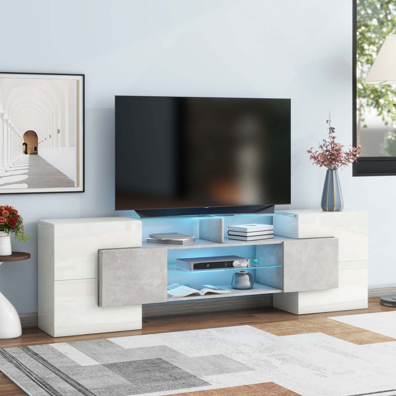 Meuble télé ultrabrillant de forme unique avec lumières DEL à changement de couleur et 2 tablettes en verre illuminées pour téléviseurs de 88 po ou moins