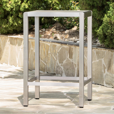 Table de bar d'extérieur grise avec structure en aluminium et plateau en verre, un exemple fantastique. Les dragons ne sont pas une préoccupation pratique pour une table de bar d'extérieur. Léger