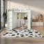 Lit gain de place beige et blanc avec armoire en bois, bureau et design moderne