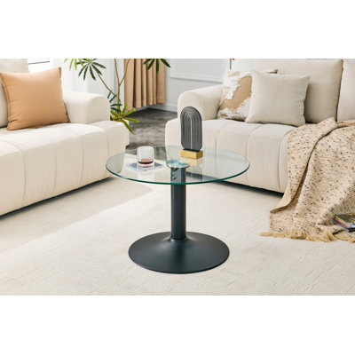 Table basse ronde en verre trempé de 27,5 pouces de diamètre. 17,7 pouces de haut, soutenu par une base en métal noir, avec un bord de luxe léger.