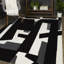 Tapis noir Houser-336624508